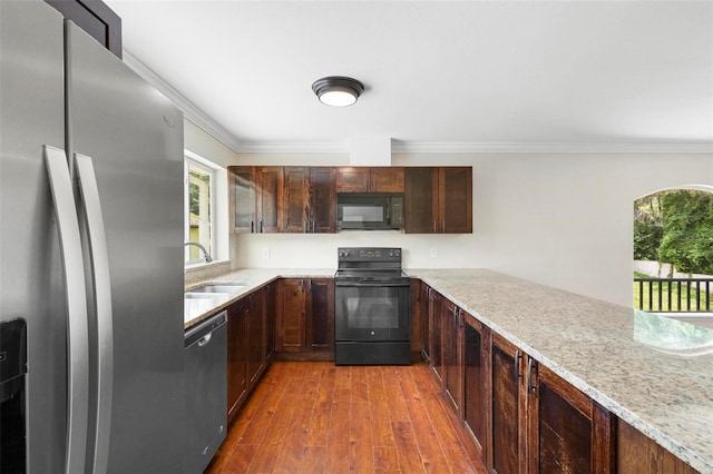 kitchen featuring crown molding, sink, light stone countertops, dark hardwood / wood-style floors, and black appliances