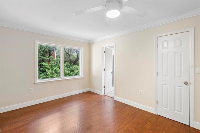 spare room featuring hardwood / wood-style flooring, ornamental molding, and ceiling fan