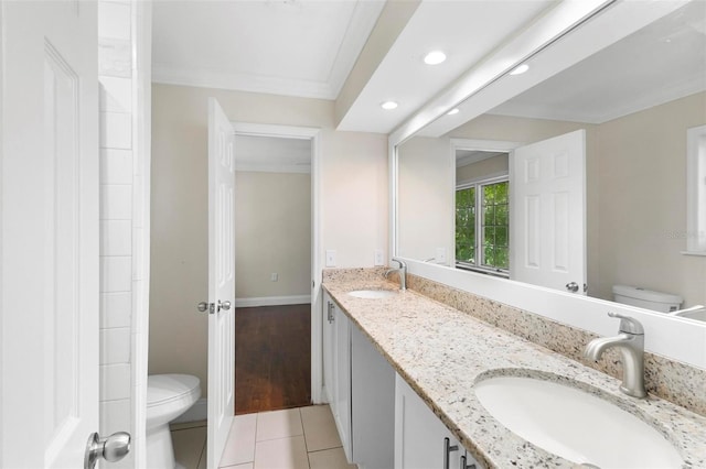 bathroom featuring vanity, toilet, crown molding, and tile patterned flooring