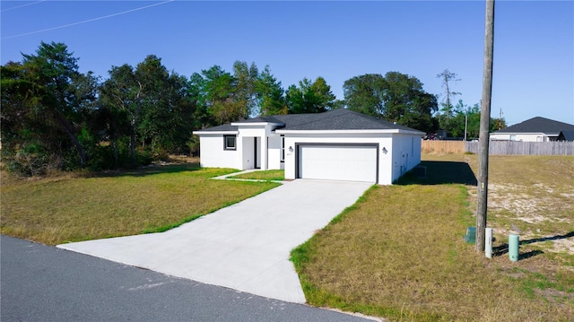 view of front facade with a garage and a front lawn