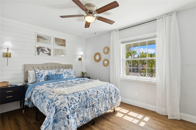 bedroom with ceiling fan and hardwood / wood-style flooring