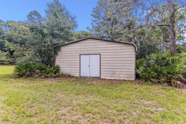 view of outbuilding featuring a lawn