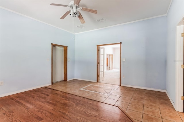 unfurnished bedroom with crown molding, ceiling fan, light hardwood / wood-style flooring, and a towering ceiling