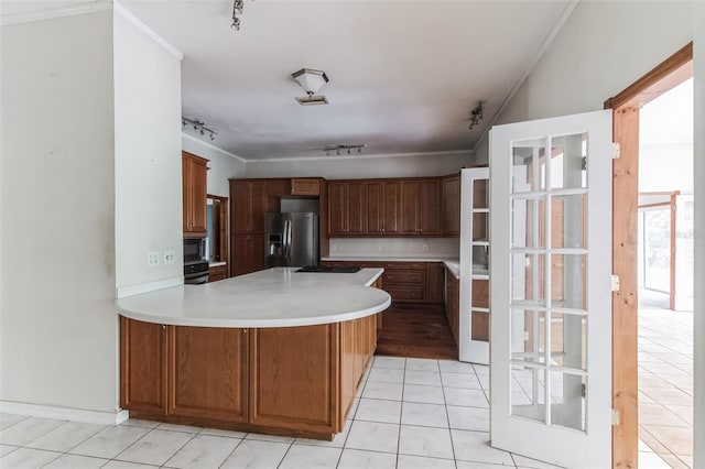 kitchen with black appliances, light tile patterned floors, kitchen peninsula, crown molding, and track lighting