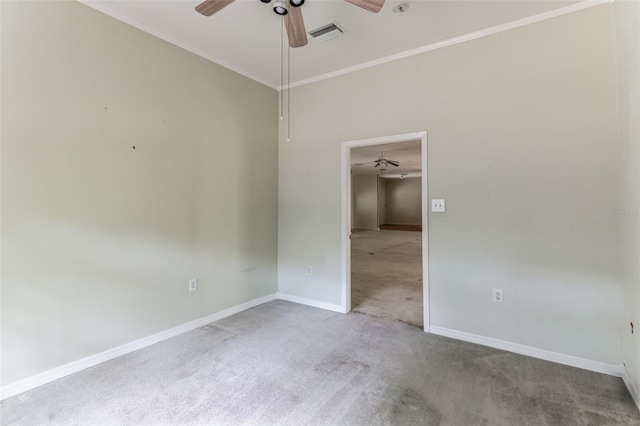 carpeted spare room featuring ceiling fan and ornamental molding