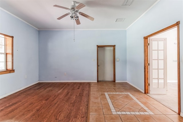 tiled spare room featuring crown molding and ceiling fan