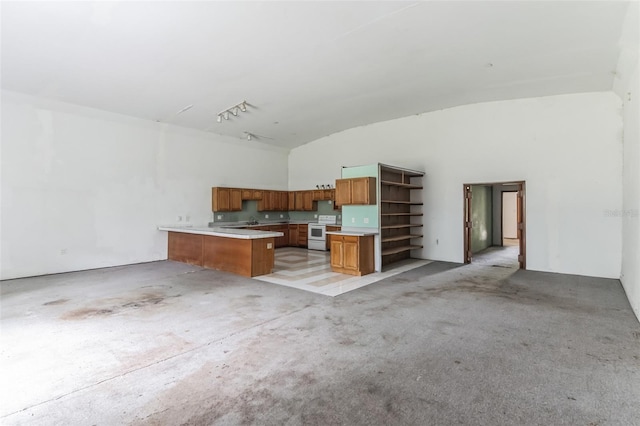 kitchen with vaulted ceiling, track lighting, kitchen peninsula, and white range with electric cooktop