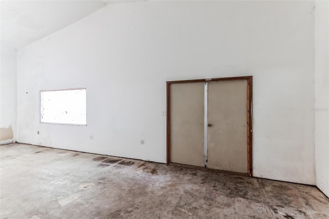 unfurnished room featuring vaulted ceiling