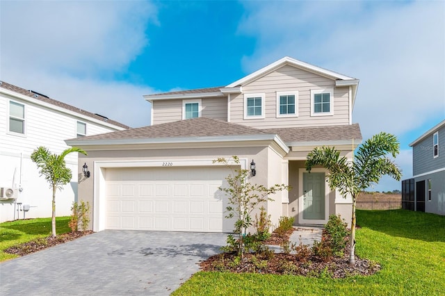 view of front of property with a garage and a front lawn