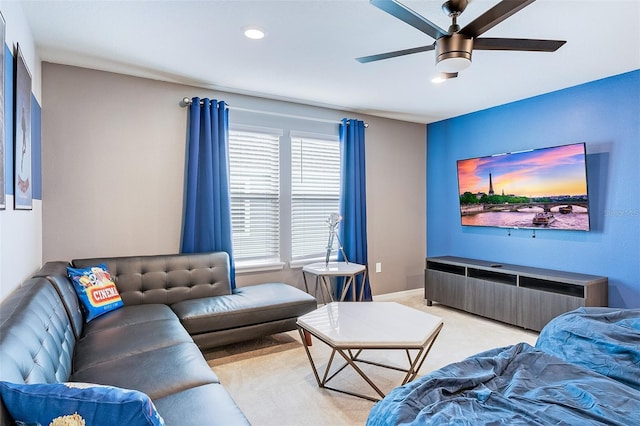 carpeted living room with ceiling fan