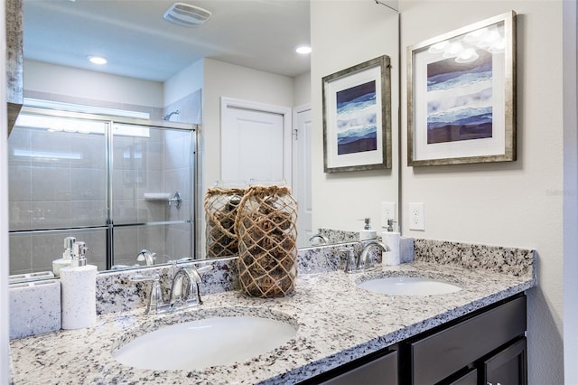 bathroom with vanity and an enclosed shower