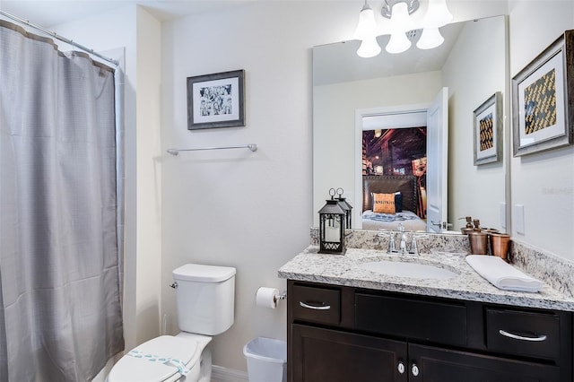 bathroom with toilet, vanity, and walk in shower