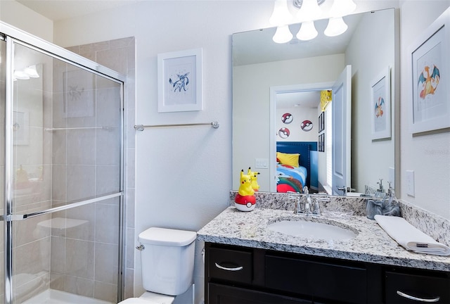 bathroom with vanity, toilet, and an enclosed shower