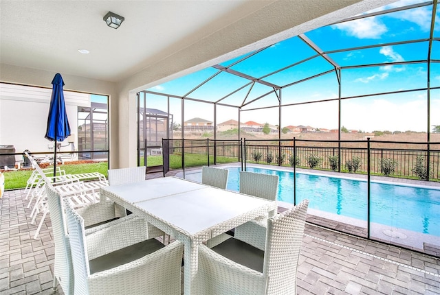 view of swimming pool with a patio, a lanai, and a rural view