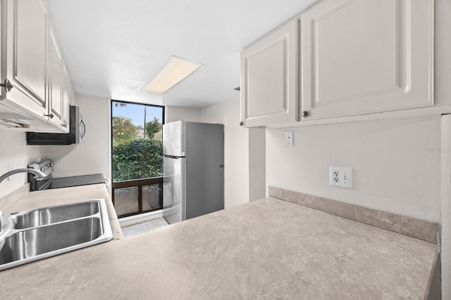 kitchen featuring white cabinets, appliances with stainless steel finishes, and sink