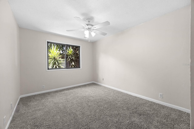 spare room featuring ceiling fan, carpet, and a textured ceiling