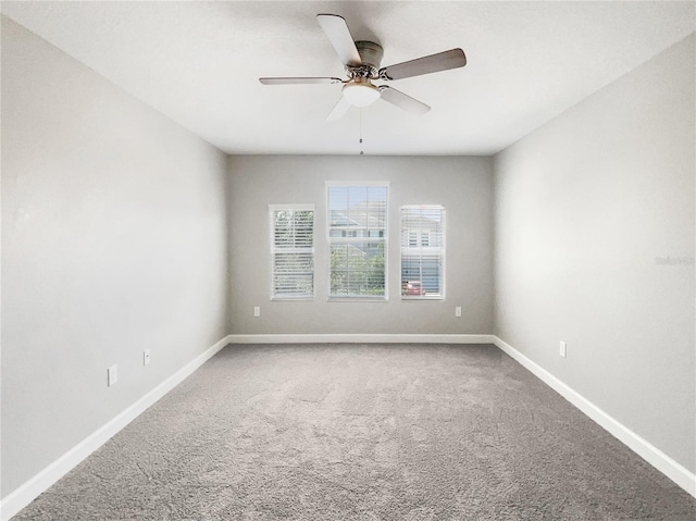 carpeted empty room featuring ceiling fan