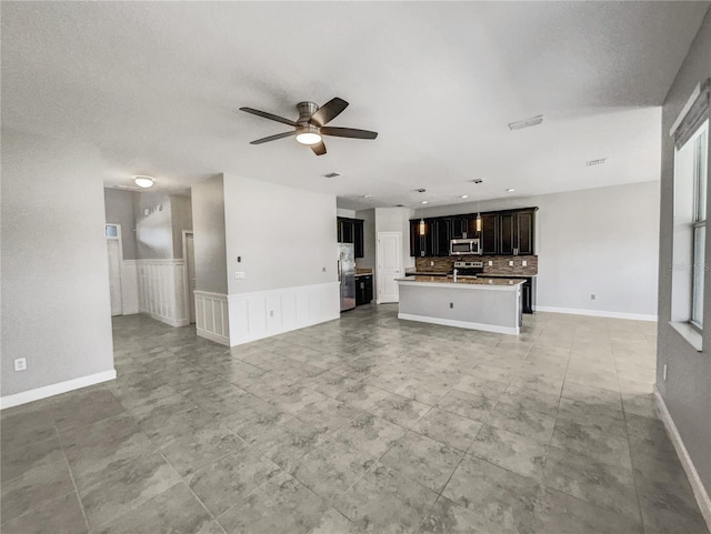 unfurnished living room featuring ceiling fan