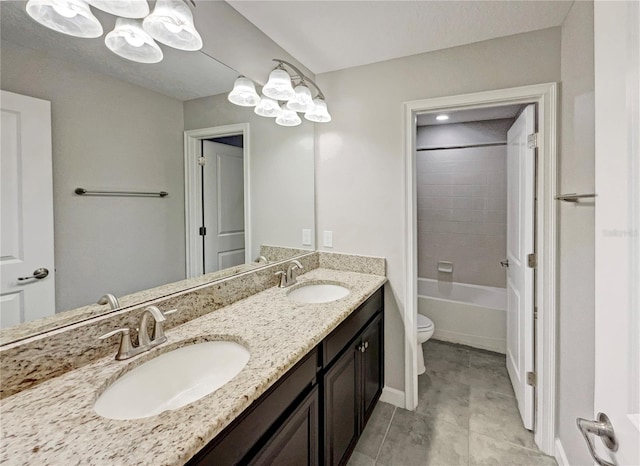 full bathroom featuring tile patterned floors, vanity, toilet, and tiled shower / bath combo