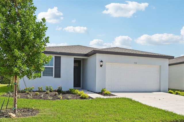 view of front of house with a front yard and a garage