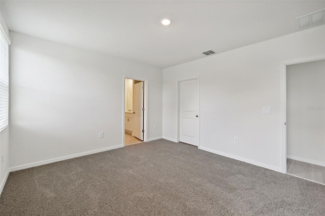 empty room with carpet floors and a healthy amount of sunlight