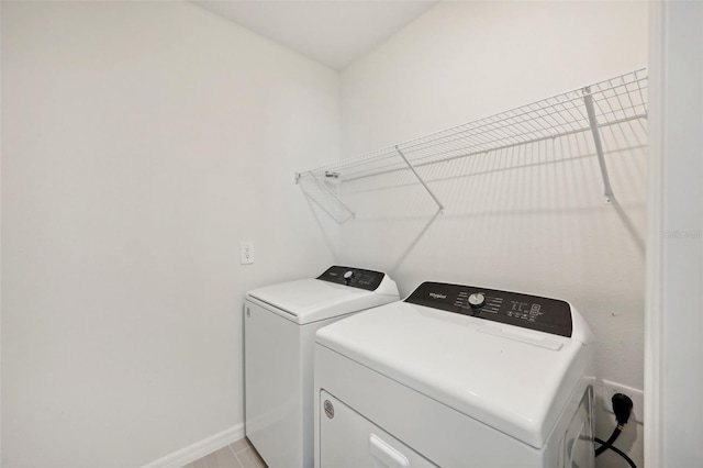 clothes washing area featuring washer and clothes dryer