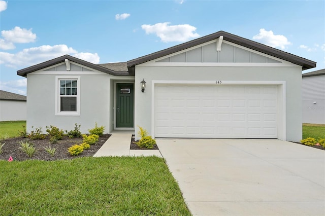 single story home with a garage, driveway, board and batten siding, and a front yard