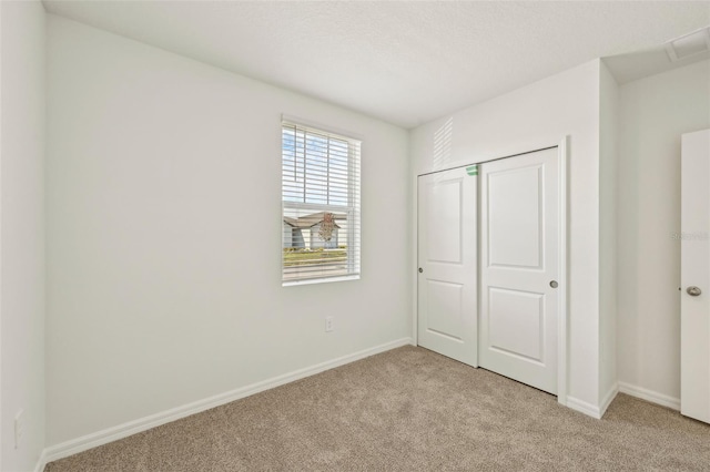 unfurnished bedroom featuring a closet and light carpet