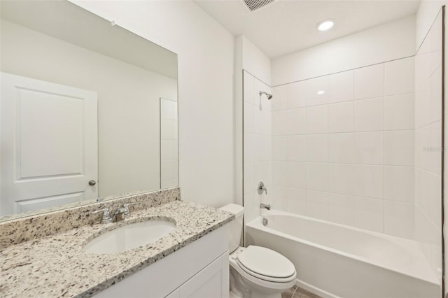 full bathroom featuring toilet, vanity, and tiled shower / bath