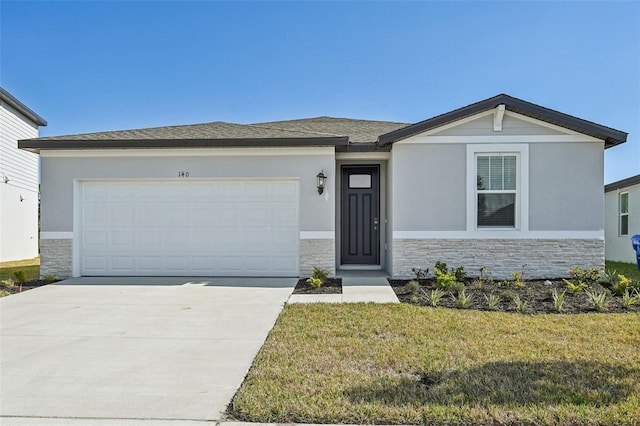 view of front facade with a garage and a front lawn