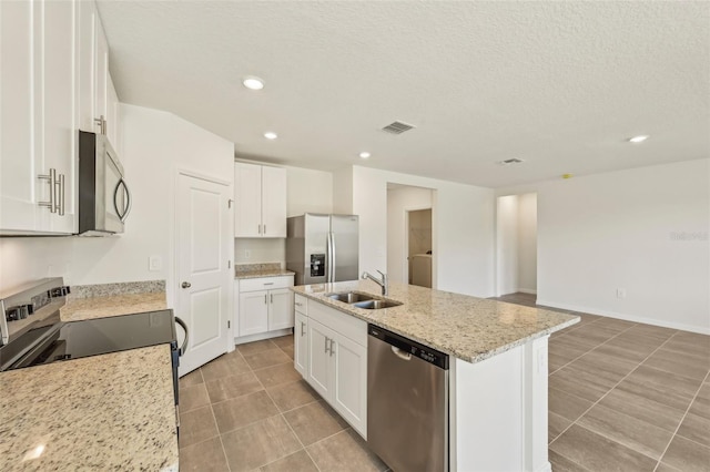 kitchen with sink, stainless steel appliances, white cabinetry, and an island with sink