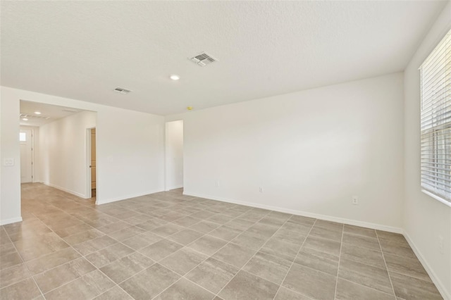 empty room featuring a textured ceiling