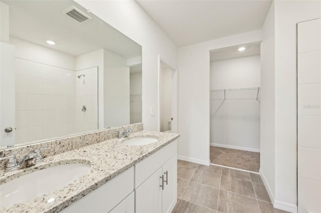 bathroom with toilet, tile patterned flooring, a shower, and vanity