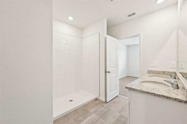 bathroom with vanity, tile patterned flooring, and walk in shower