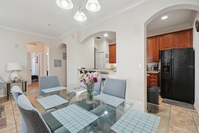 tiled dining room featuring crown molding