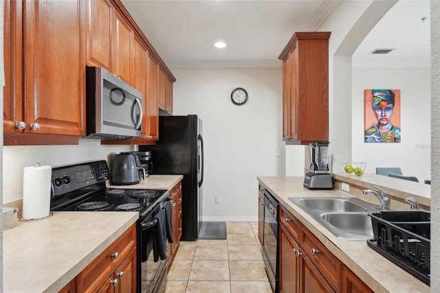 kitchen with black appliances, sink, light tile patterned floors, and crown molding