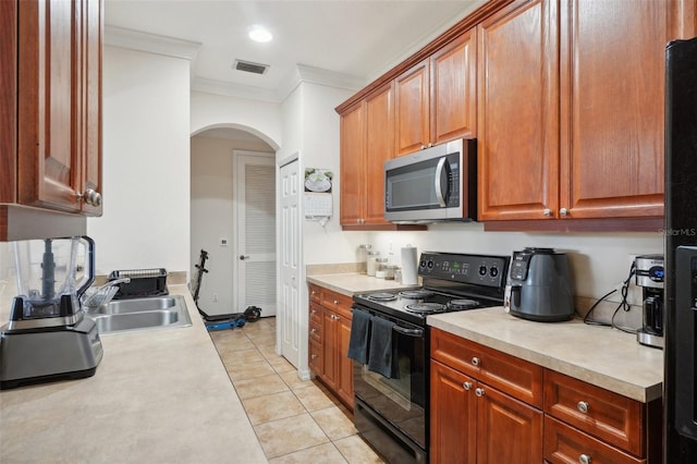 kitchen featuring crown molding, sink, light tile patterned floors, and black appliances