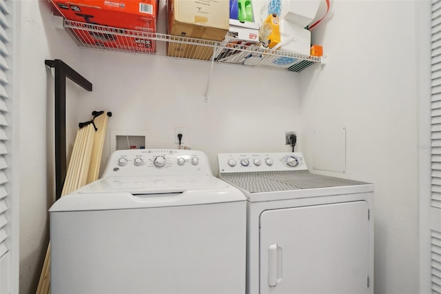 clothes washing area with separate washer and dryer