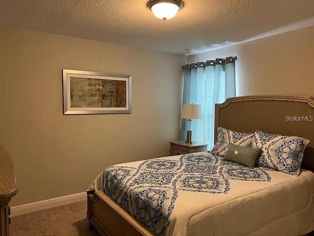 carpeted bedroom featuring a textured ceiling