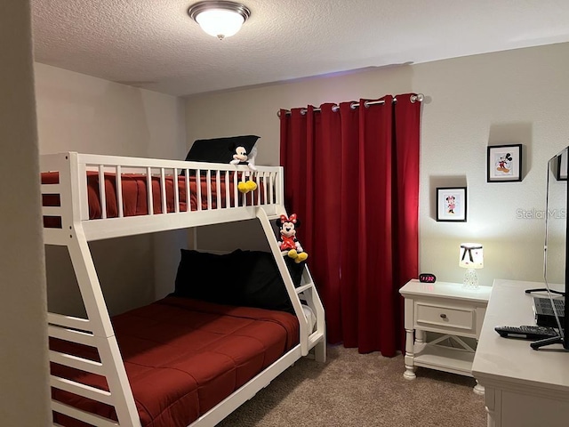 carpeted bedroom featuring a textured ceiling