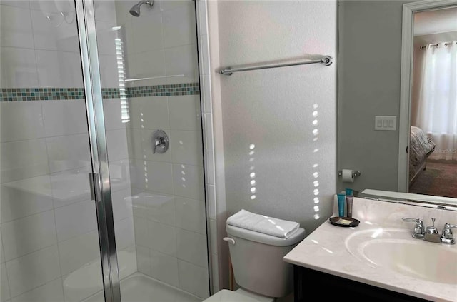 bathroom with vanity, toilet, and an enclosed shower