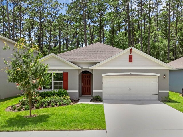 ranch-style home with a garage and a front lawn