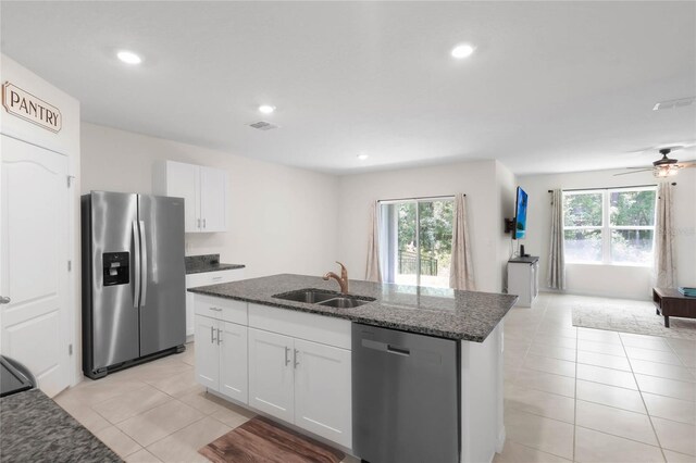 kitchen with light tile patterned floors, ceiling fan, appliances with stainless steel finishes, sink, and plenty of natural light