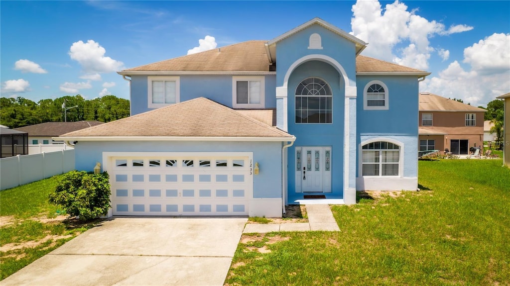 view of front of property with a front yard and a garage