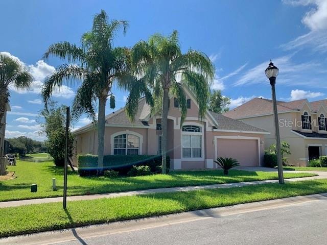 single story home with a front lawn and a garage