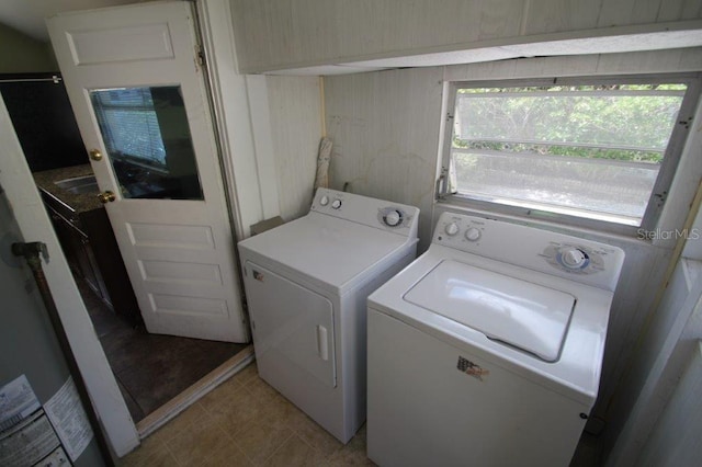 washroom with washing machine and clothes dryer