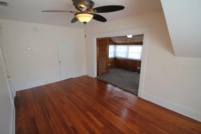 empty room featuring ceiling fan and dark wood-type flooring