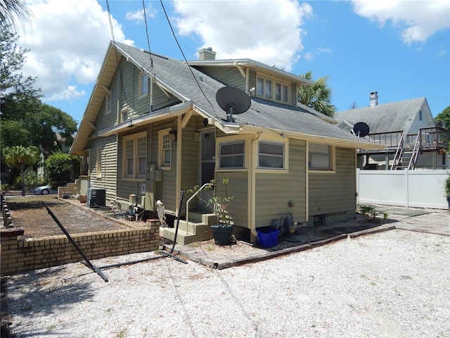 rear view of house with cooling unit