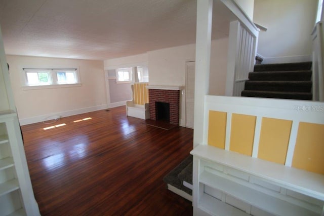 unfurnished living room featuring dark hardwood / wood-style flooring and a fireplace