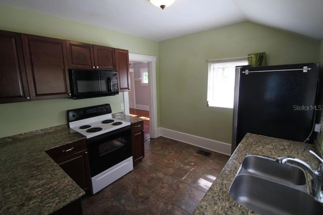 kitchen featuring black appliances, dark brown cabinets, sink, and vaulted ceiling